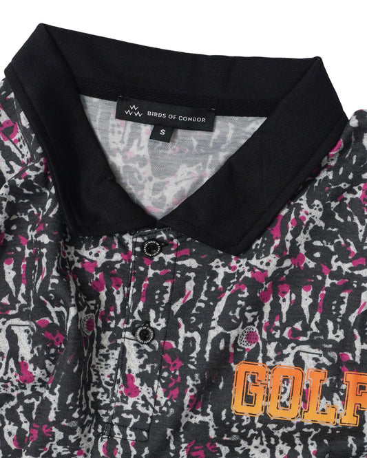 Detail of a black polo shirt featuring a pink golf print, black collar, two-button placket, and orange GOLF text.