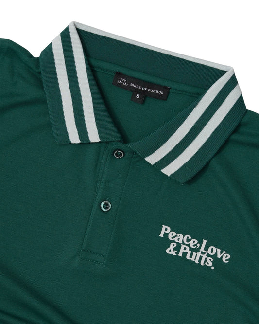 Detail of a green polo shirt featuring a white striped collar and Peace, Love & Putts chest print.
