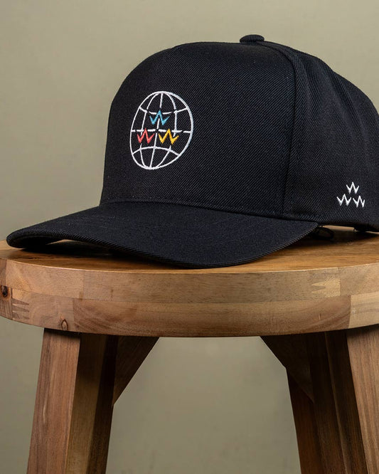 Black five-panel snapback cap featuring a white globe graphic with multi-coloured V motifs on the crown.
