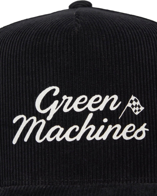 Front of a black corduroy snapback featuring a white script Green Machines text and checkered flag logo.
