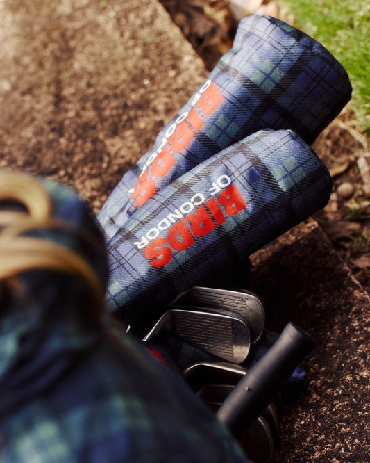 Blue and green plaid headcover with bold orange and white BIRDS OF CONDOR graphic text.