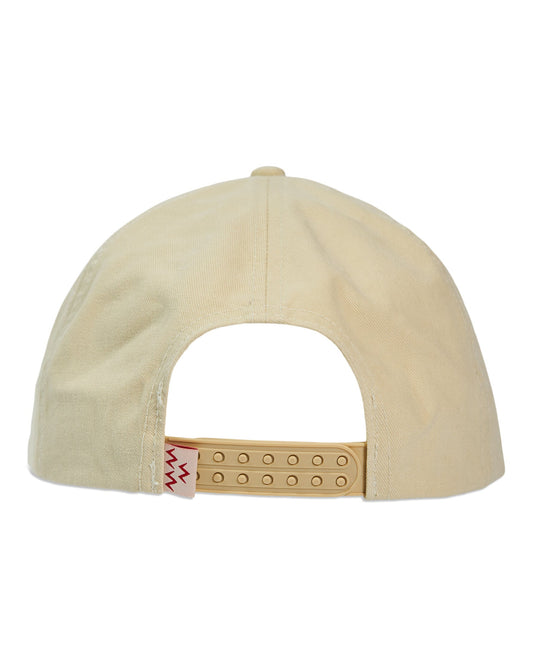 Back of a cream snapback hat with a double plug closure and a small red zig-zag label on the strap.