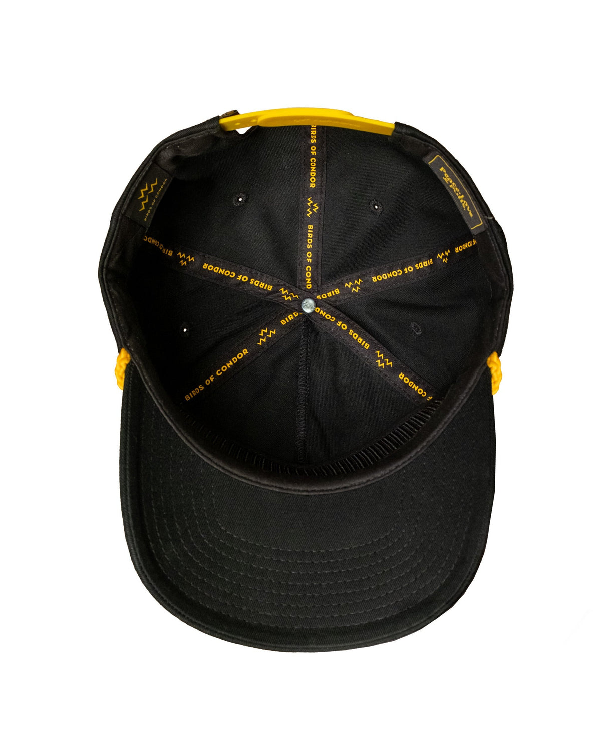 Detail of the inside of a black cap with yellow printed internal taping and a yellow snapback closure.