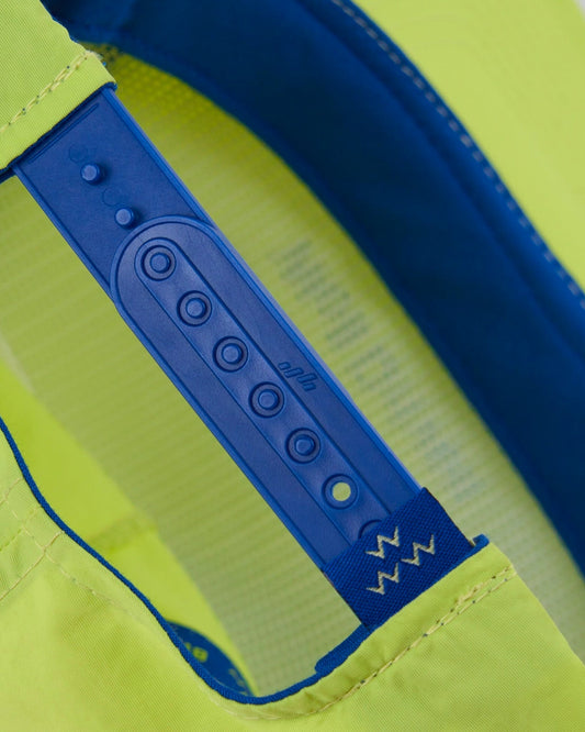 Detail of a lime snapback hat featuring an adjustable blue plastic back strap.