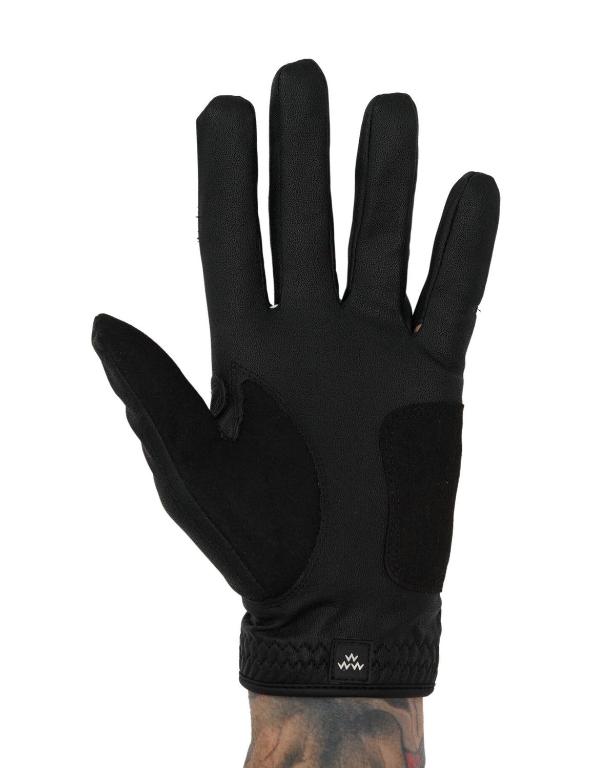 Front of a black golf glove featuring a contrasting suede palm patch and a small white logo.
