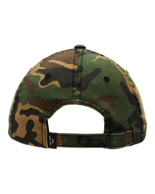 Back of a camo cotton cap with an adjustable strap, metal buckle, and a small black woven tag.