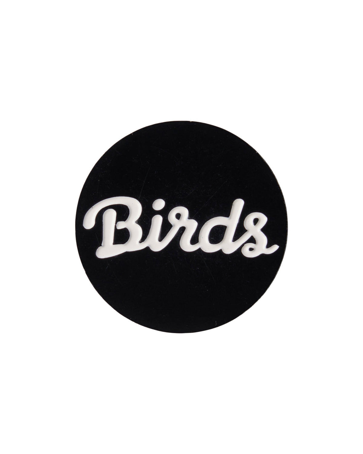 A black golf ball marker featuring the white script graphic Birds across the center.