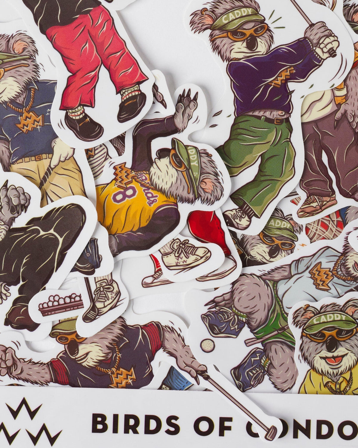 Detail of white stickers featuring various koala characters playing golf in colourful outfits.