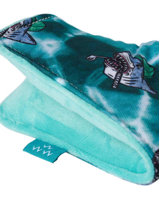 Detail of a teal tie-dye blade headcover with shark graphics and a soft aqua velvet lining.