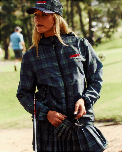 A woman wearing a blue and green plaid shell jacket with a zipped front and embroidered chest logo.