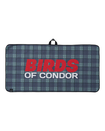 A green and blue plaid golf towel featuring large red and white printed text reading BIRDS OF CONDOR.