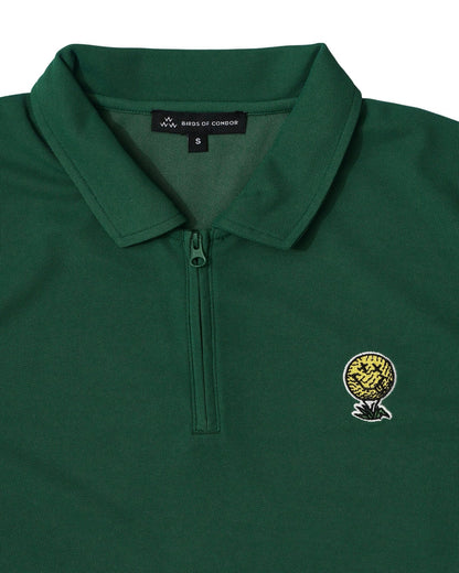 Detail of a green quarter-zip polo shirt featuring an embroidered Neverfind golf ball logo.