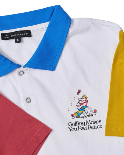 Detail of a white cotton polo shirt featuring a blue collar, yellow sleeve, and red sleeve with a cartoon golfer graphic.