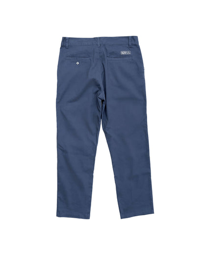 Back of navy pants featuring a fixed waistband with belt loops, two welt pockets, and a small brand logo.