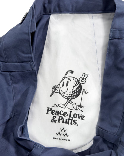 Detail of blue cotton pants showing a white pocket interior with a golf graphic and Peace, Love & Putts text.