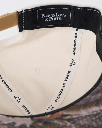 Detail of the natural snapback interior, featuring branded inner taping and a woven patch.