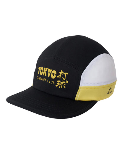 Black sports cap with white and yellow side panels, a flexible brim, and a yellow Tokyo Country Club print.