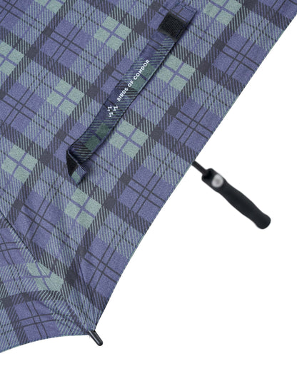 Detail of a blue and green plaid umbrella with a branded velcro tie and black handle.