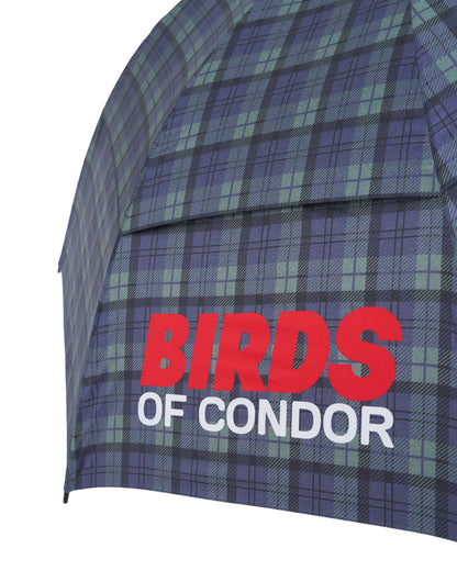 Detail of a blue and green plaid umbrella featuring a red and white Birds of Condor logo print.