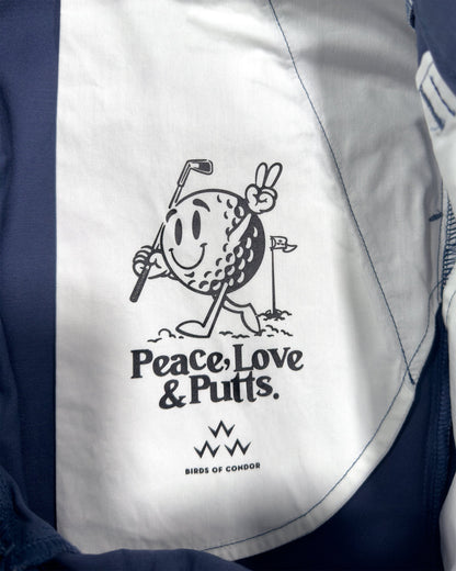 Detail of blue shorts with a printed inner pocket featuring a smiling golf ball holding a club.