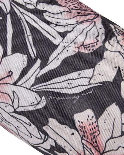 Detail of an azalea print 3 wood headcover with a dark background and pale pink floral design.