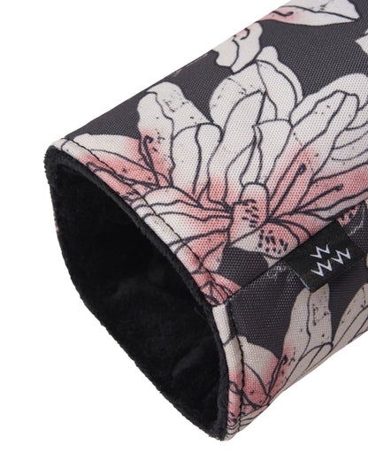 Detail of an azalea print headcover featuring a pink floral design, black inner lining, and a small branded tab.
