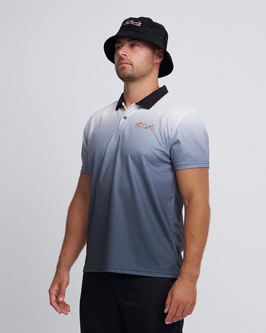 A man wearing a black gradient polo shirt with a black collar and a small printed left chest design.