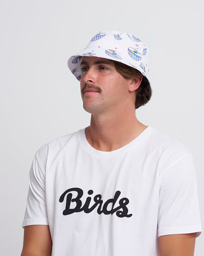 A man wearing a white bucket hat featuring an all-over blue graphic of a disco ball golf cart.