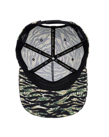 The inside view of a baseball cap featuring a tiger-stripe camouflage pattern on the brim and a gray and black zebra-patterned fabric on the back panels, with black adjustable straps.