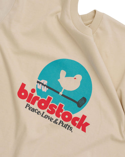 Detail of a natural t-shirt featuring a blue circle, a bird on a golf club, and red birdstock text.