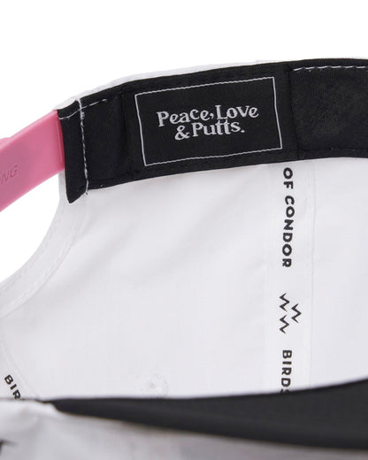 Detail of the inside of a white nylon snapback with a pink strap and a black inner label.