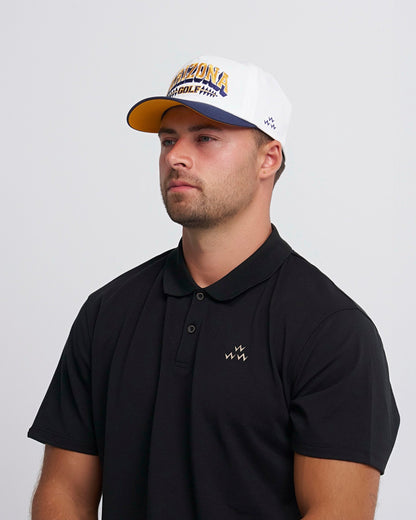A man wearing a white snapback with a navy brim, yellow under brim, and an Arizona Golf front design.