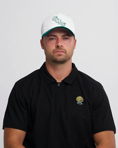 Man wearing a black polo shirt with a neverfind logo and a white cap with 'Golf' text on a light gray background