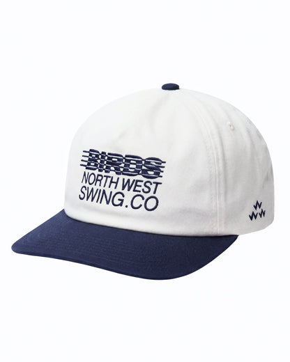 Front of a white cotton snapback with a navy brim, navy top button, and navy typography front embroidery.