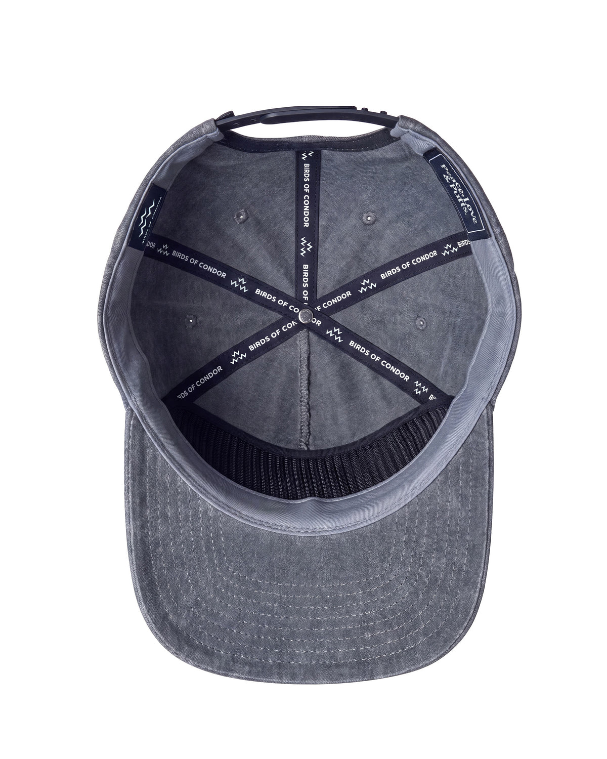 Interior view of a black denim snapback cap featuring branded seam tapes and adjustable back strap in detail shot.