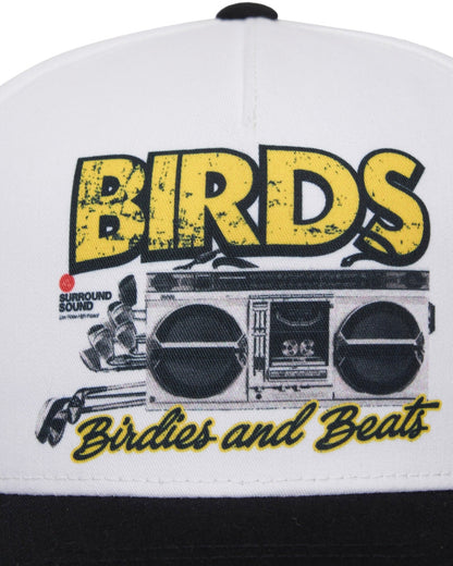 White snapback cap with a black brim and a graphic of a boombox and text reading birds and beats.