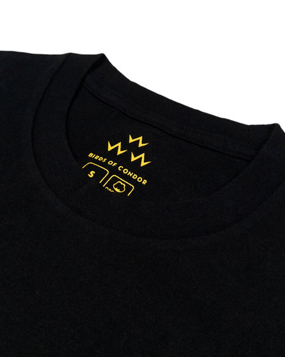 Detail of the inside collar of a black t-shirt featuring yellow printed branding and size small.