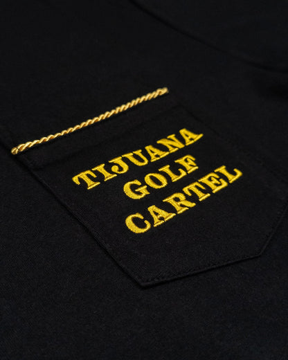 Detail of a black cotton t-shirt featuring a pocket with twisted gold trim and embroidered yellow text.