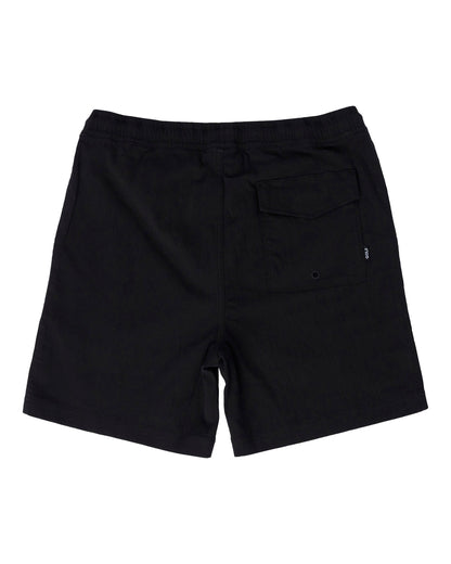 Back of black shorts featuring an elastic waistband and a Velcro flap back pocket with a small logo tag.