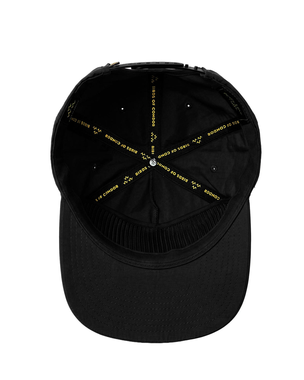 Inside of a black snapback cap featuring yellow logo text printed on the interior seam taping.