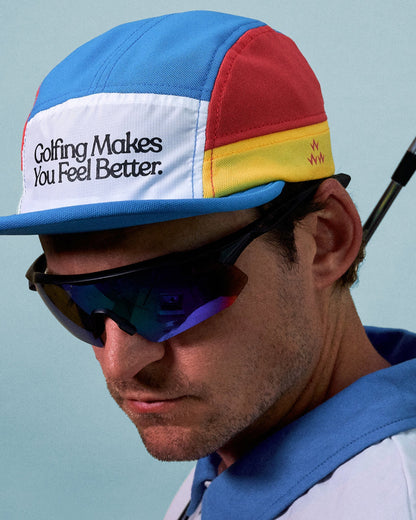 A man wearing a multi-colour 8-panel sports cap with text on the white front panel.