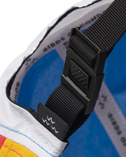 Detail of a white, red, and yellow sports cap with a black strapback buckle.