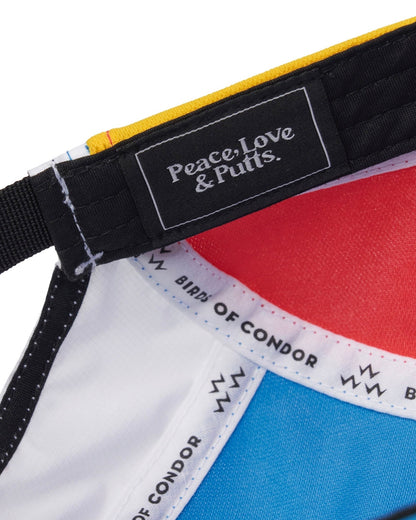 Detail of the interior lining of a white sports cap, showing a black strap tag with the text Peace, Love & Putts.