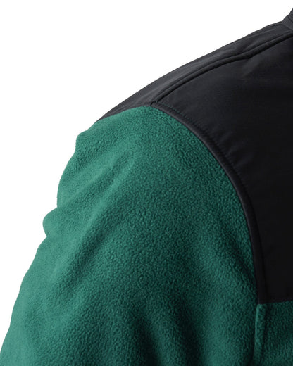 Detail of an amazon green fleece sweater featuring a black ripstop shoulder panel.