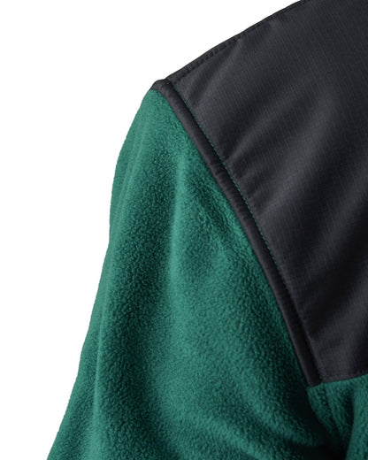 Detail of an amazon green polar fleece sweater with a black polyester ripstop shoulder panel.