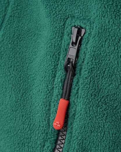 Detail of an amazon green polar fleece sweater featuring a black zipper with a red puller.