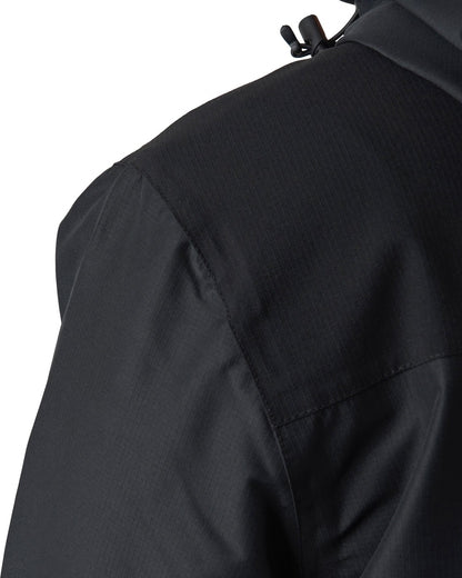 Detail of a black jacket showing the shoulder stretch panel, hood drawstrings, and smooth fabric sleeves.