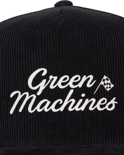 Front of a black corduroy snapback featuring a white script Green Machines text and checkered flag logo.