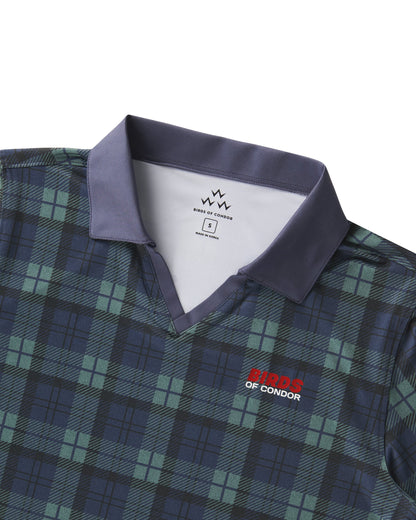 Detail of a blue and green plaid polo shirt with a solid collar, V-neck, and red and white chest logo.