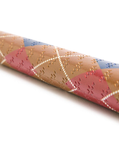 Detail of an argyle putter grip in brown, red, and blue with an embossed allover logo design.